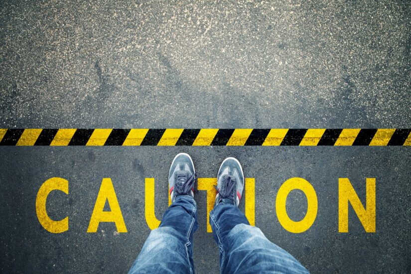 Premises Liability Caution Image Of A Person Standing On Ground With Caution Sign